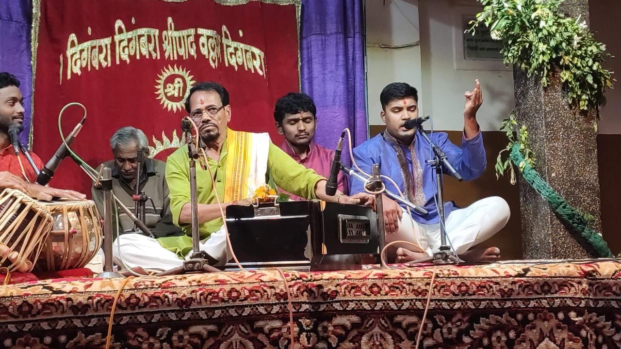 Amey Bansod performing Indian classical music on stage with an ensemble