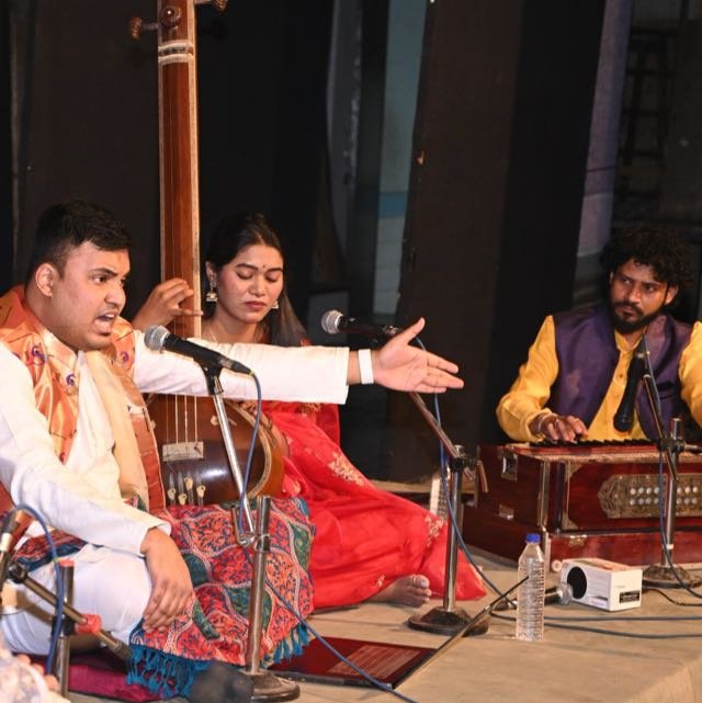 Amey Bansod singing on stage with classical musicians